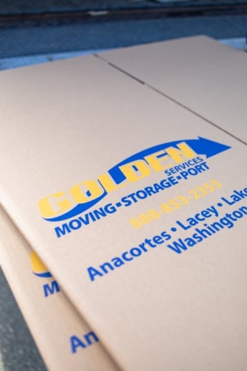 Close-up of the Golden Services moving, storage and port services logo printed on a cardboard box